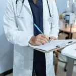 https://www.pexels.com/photo/doctor-writing-on-a-medical-chart-6129043/