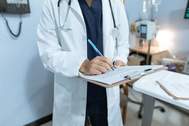 https://www.pexels.com/photo/doctor-writing-on-a-medical-chart-6129043/